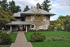 Photograph of a large house with landscaped grounds